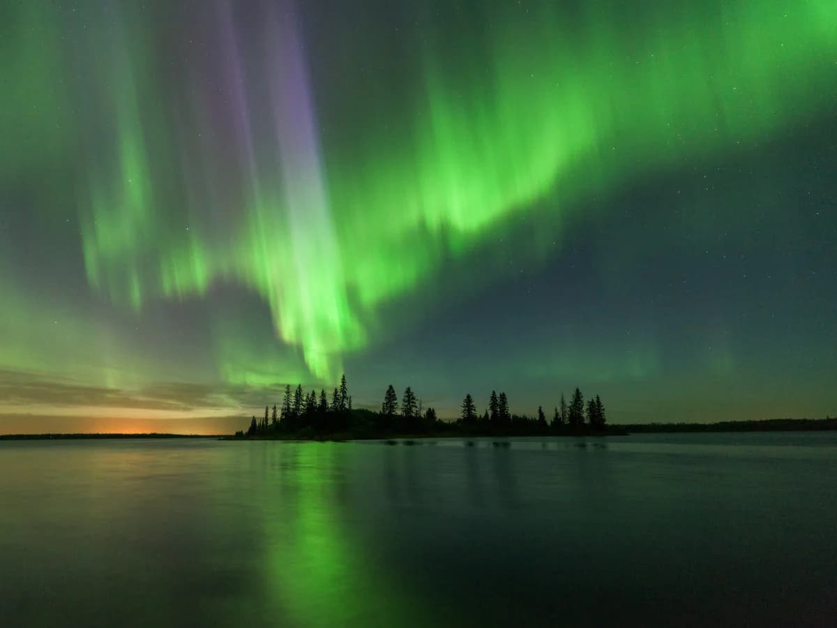Northern lights over Alberta wilderness